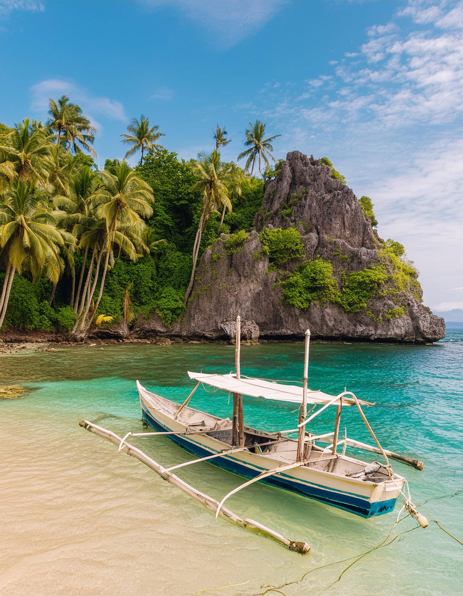 Castaway Tours expedition boat anchored in a lagoon between El Nido and Coron, Palawan