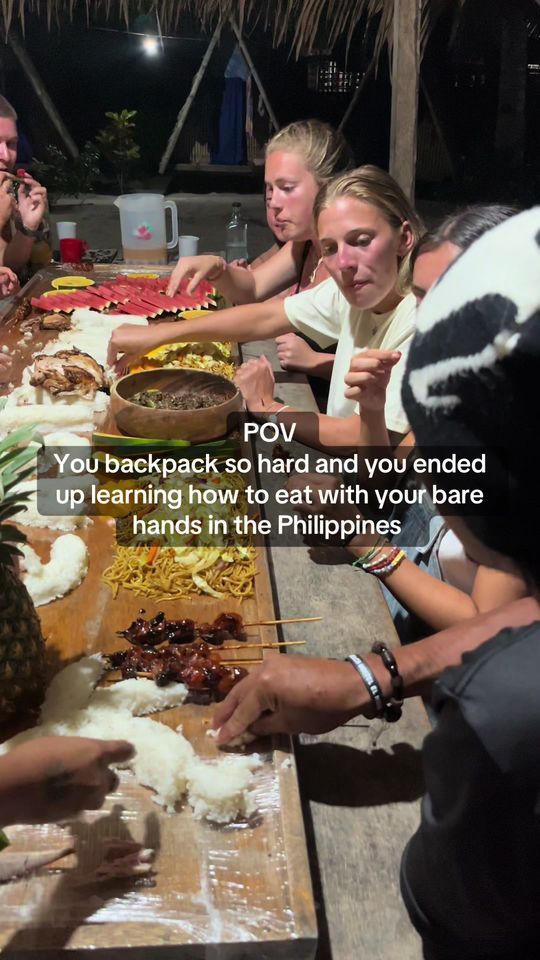 Guests sharing a traditional Filipino boodle fight dinner at a Castaway island basecamp